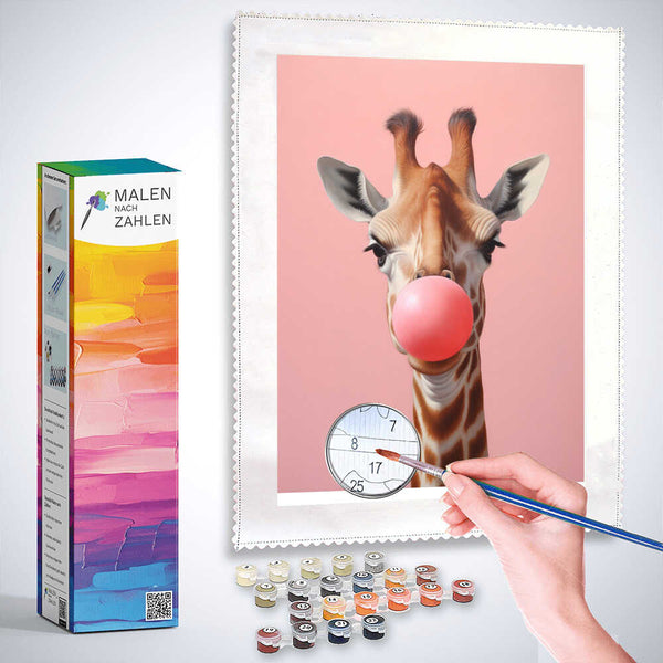 Paint by numbers - Giraffe with pink bubble gum painting kit against a pink background, includes brush and paint containers.