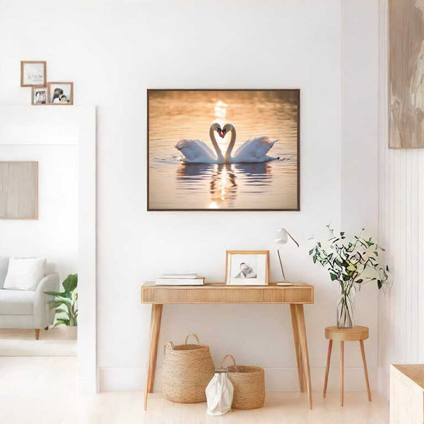 Painting of two swans forming a heart shape, titled "Verborgene Zärtlichkeit im Abendlicht," in a serene living space.