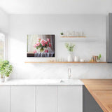 Painting of pastel pink and white peonies in a vase on a draped table, set in an elegant kitchen with white and wooden decor.
