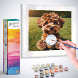 Person painting by numbers a charming dog on a canvas with paint supplies and Malen nach Zahlen kit on the side