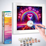 Person painting a colorful Malen nach Zahlen image featuring a heart and rainbow with supplied paint and brush.