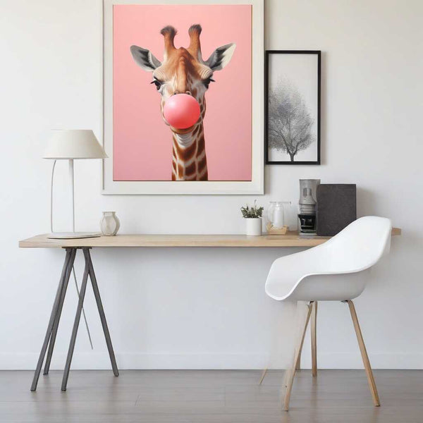 Giraffe blowing pink bubble gum painting, "Kaugummikuss", in a modern minimalist room with white desk and chair.