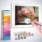 Painting by numbers kit with morning light and peonies, featuring a hand holding a brush, painting delicate flowers in a glass vase.