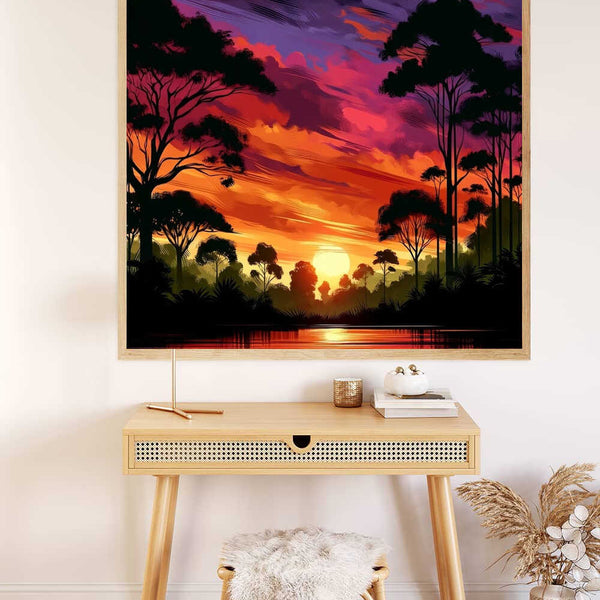 Malen nach Zahlen Leinwand mit einem farbenfrohen Sonnenuntergang im Geheimen Wald, aufgehängt über einem Schreibtisch mit Dekor.