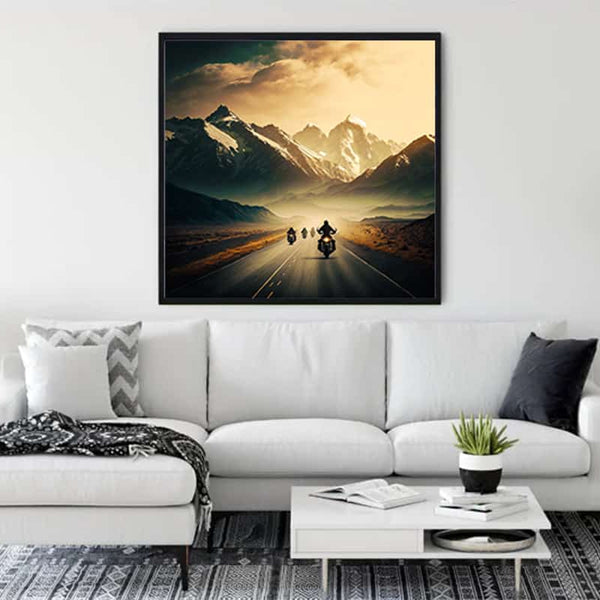 Wall art depicting motorcyclists riding towards snowy mountains, enhancing a modern living room with a stylish, relaxing ambiance.