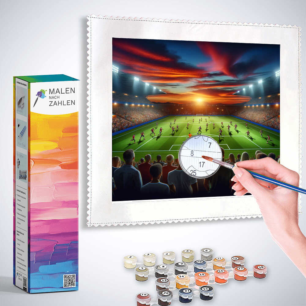 Malen nach Zahlen - Abendglühen im Stadion - Paint by numbers kit with a sunset stadium scene, a hand painting, and painting supplies.
