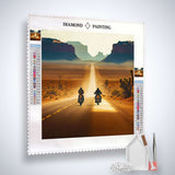 Diamond painting kit with motorcyclists on desert road, includes canvas, acrylic diamonds, tweezers, and setting pen