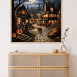 Halloween village scene with carved pumpkins, moonlit sky, and spooky houses on cobblestone street displayed above wooden cabinet.