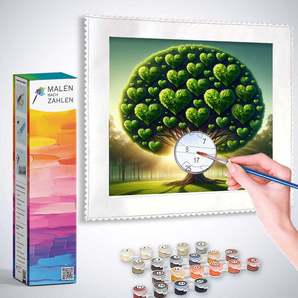 Painting by numbers kit - Herzensbaum: Zauber der Natur with heart-shaped tree, color palettes, and paintbrush in hand while painting.