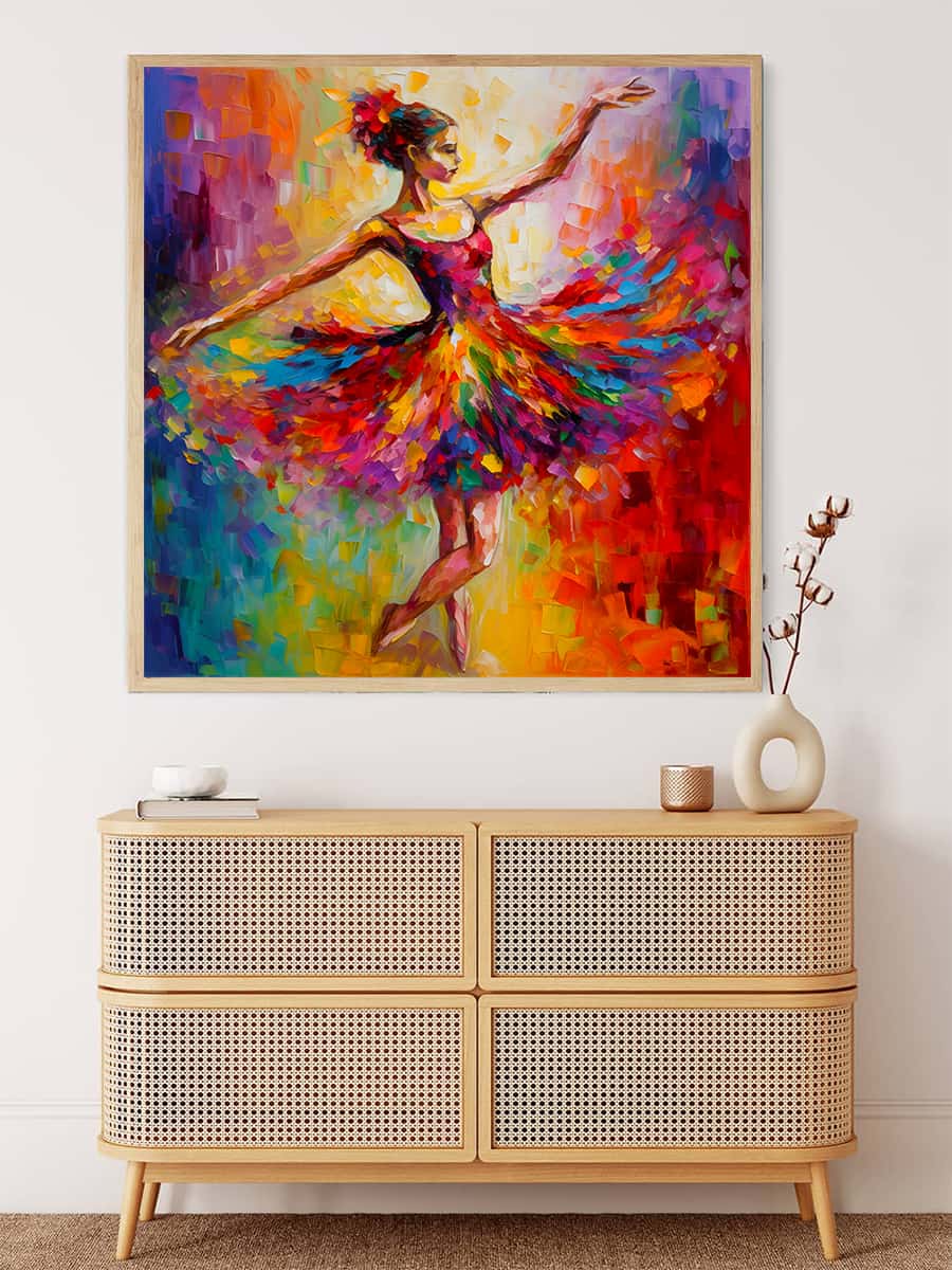 Abstract painting of a dancing ballerina in colorful dress, framed and hung above a wooden dresser with decorative items.