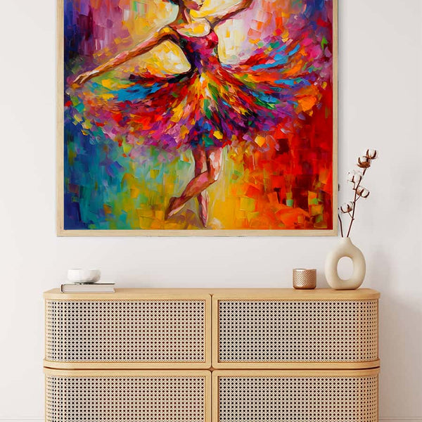 Abstract painting of a dancing ballerina in colorful dress, framed and hung above a wooden dresser with decorative items.
