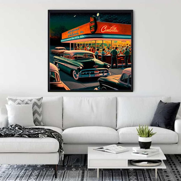 Painting of a vintage gas station with classic cars hung above a white couch in a modern living room