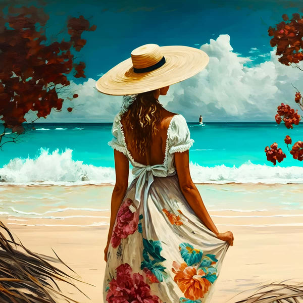 Woman wearing wide-brimmed hat and floral dress standing on beach, looking at calm ocean with sailboat, surrounded by red foliage.