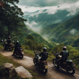 Four motorcyclists riding through scenic mountain landscape surrounded by lush green hills and misty clouds