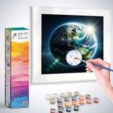 Paint by Numbers - Awakening of the Blue Planet with painting supplies and hand holding brush