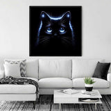 Modern living room with white sofa and neon glow dark cat wall art.