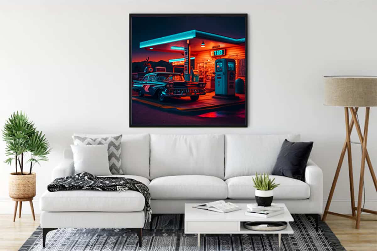 Living room with framed 50s gas station art, white sofa, modern decor, Malen nach Zahlen - 50er Jahre Tankstellenromantik painting.