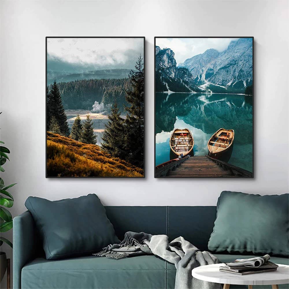 Nature landscape paintings with black aluminum frames displayed above green sofa in modern living room.