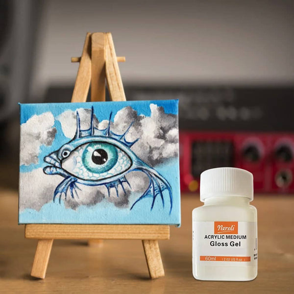 Painting of an eye with clouds on a mini easel next to a bottle of Spezial Versiegelung acrylic gloss gel