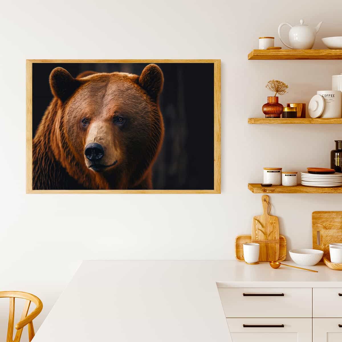 Portrait of a brown bear painting displayed in a modern kitchen with wooden shelves and white decor.