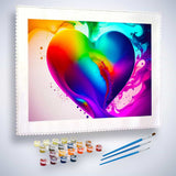 Paint by Numbers kit featuring a rainbow heart framed by swirling colorful clouds, with paint pots and brushes included