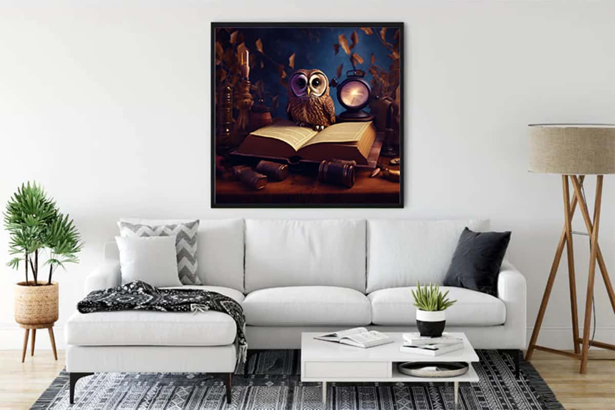 Wall art featuring an owl with a book and a clock, displayed above a modern white sofa in a well-decorated living room.