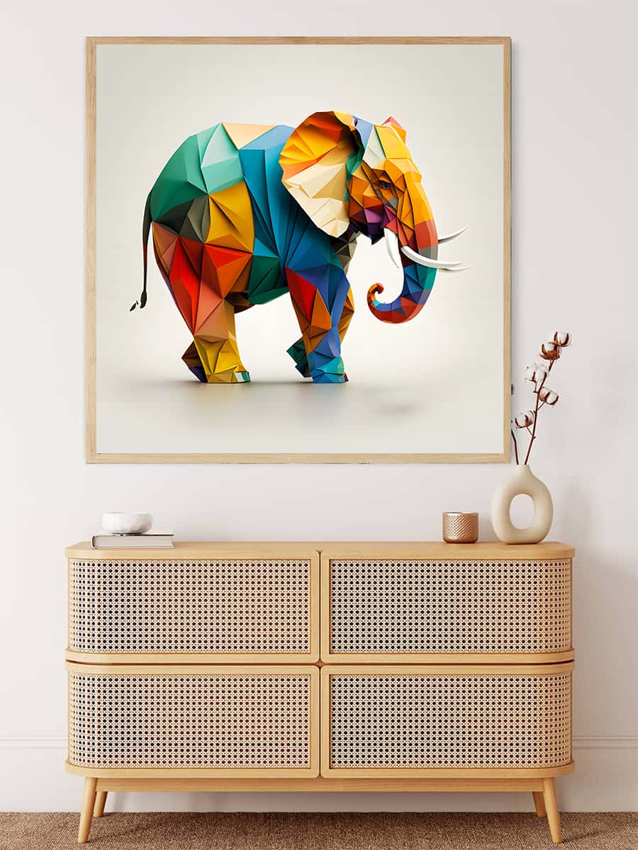 Colorful geometric elephant paper art painting displayed above a wooden chest in a modern decor setting.