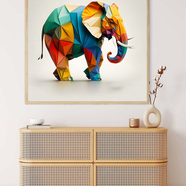 Colorful geometric elephant paper art painting displayed above a wooden chest in a modern decor setting.