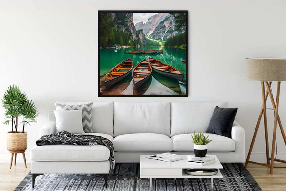 Wall art with boats and mountain panorama in a serene lake scene displayed in a modern living room.
