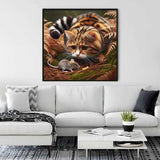 Painting of a cat and mouse in autumn forest on wall above modern white couch with black and white cushions and decor