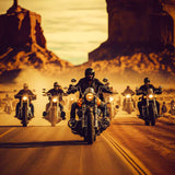 Group of bikers riding through desert landscape at sunset