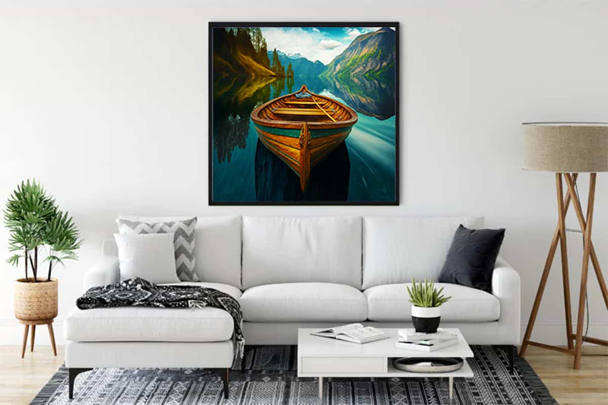 Painting of a boat on a calm lake surrounded by mountains, displayed above a white couch in a modern living room.