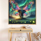 Painting by numbers artwork featuring a luminous butterfly-elephant hybrid against a starry night sky, hung above a modern desk.