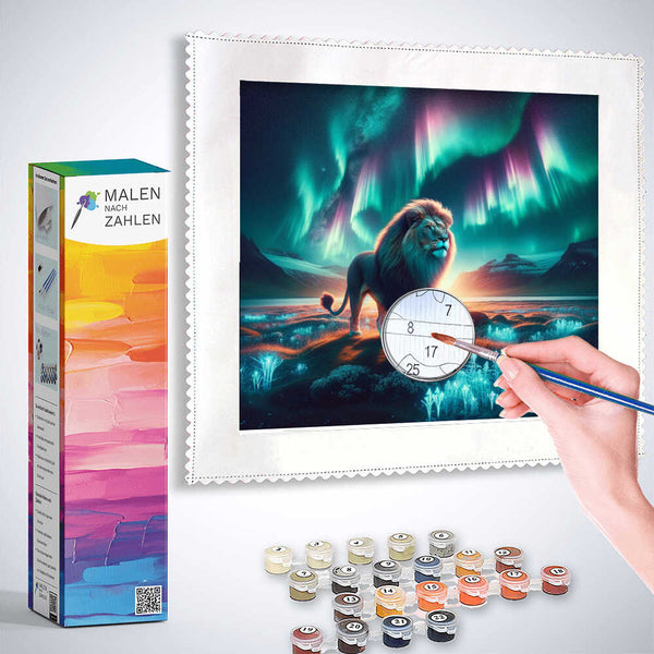 Painting by Numbers kit with a majestic lion under the Northern Lights, featuring paints, brushes, and a framed canvas illustration.