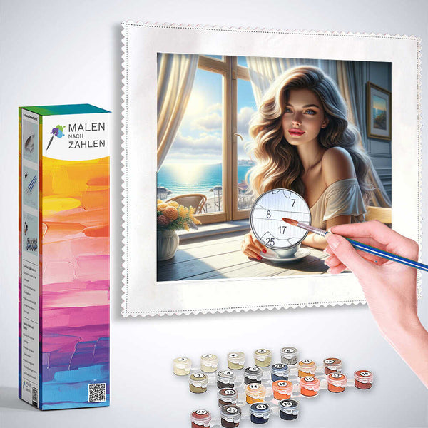 Person painting by numbers kit "Morgenglanz am Meer" featuring a woman by the sea, with vibrant colors and detailed paint containers