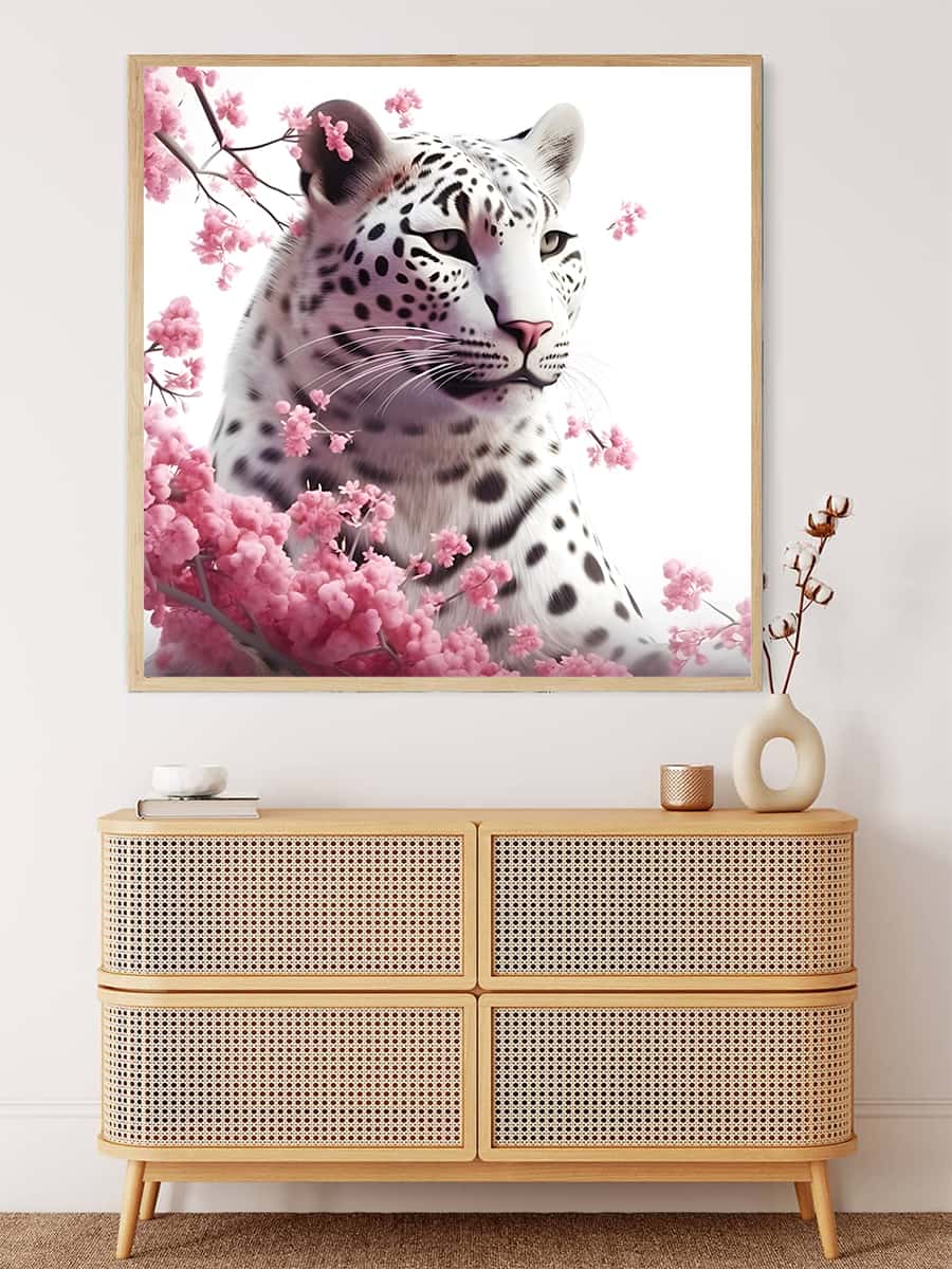 Painting of a snow leopard with blooming roses on a wall above a modern wicker drawer unit