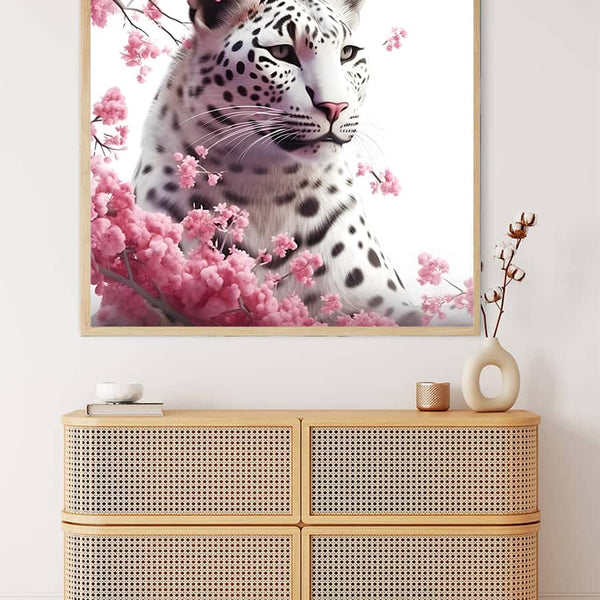 Painting of a snow leopard with blooming roses on a wall above a modern wicker drawer unit