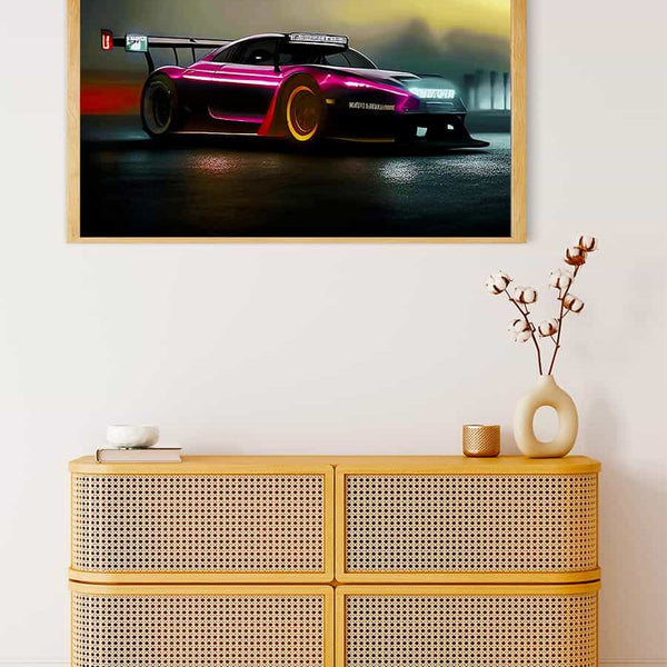 Painting of a sportscar racing at night framed on a wall above a stylish wooden dresser with decorative items.