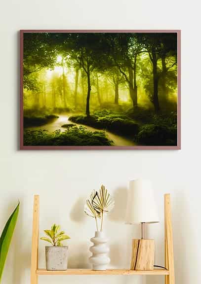 Painting of a serene river in a green forest, framed and hung on a wall above a wooden shelf with plants and a lamp