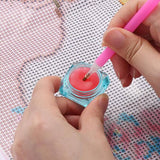 Applying pink wax to diamond painting pen for premium quality diamond art project