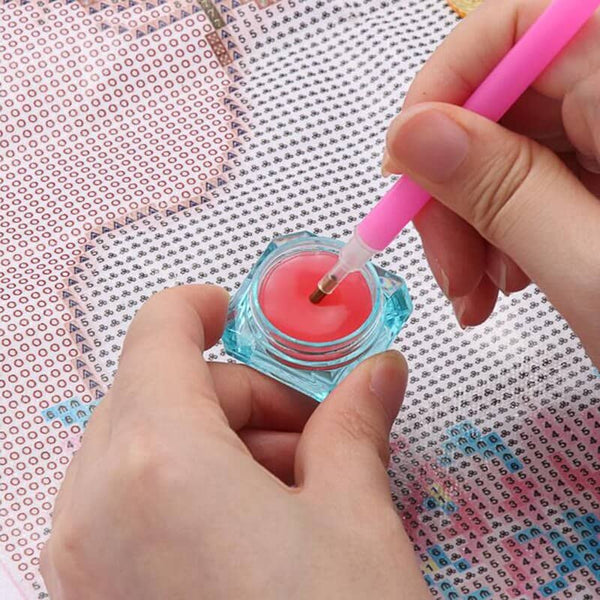 Applying pink wax to diamond painting pen for premium quality diamond art project