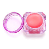 Open jar of premium diamond painting pink wax with purple lid.